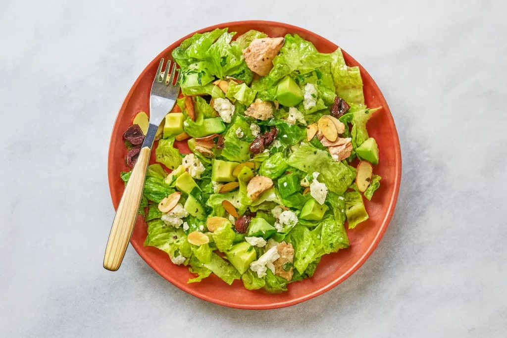 
Avocado tuna salad with romaine, feta, Kalamata olives, and almonds, a nutrient-dense dish perfect for weight loss recipes.